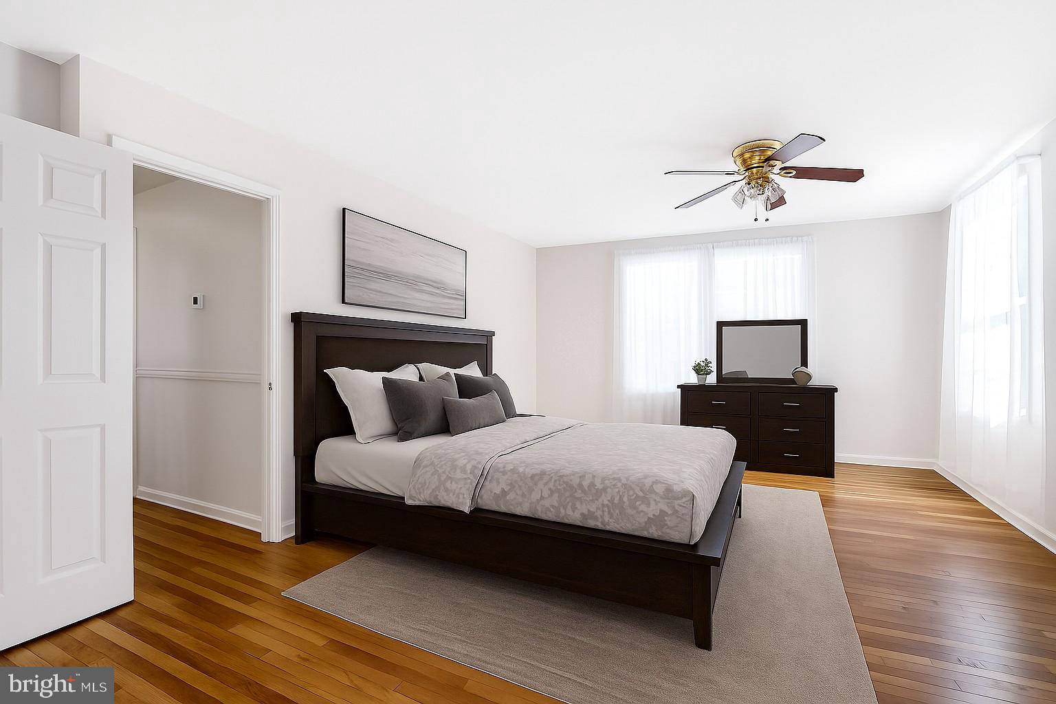 6710 Red Jacket Road Springfield, VA 22152 - Photo 30 of 53 a bedroom with a bed and wooden floor