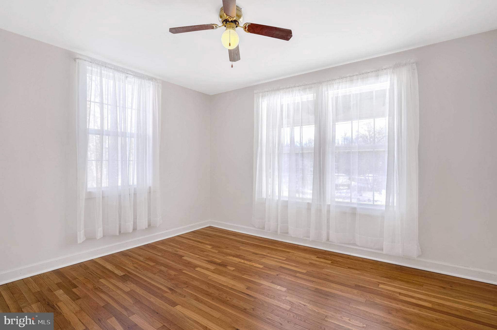 6710 Red Jacket Road Springfield, VA 22152 - Photo 37 of 53 a view of an empty room with wooden floor and a window