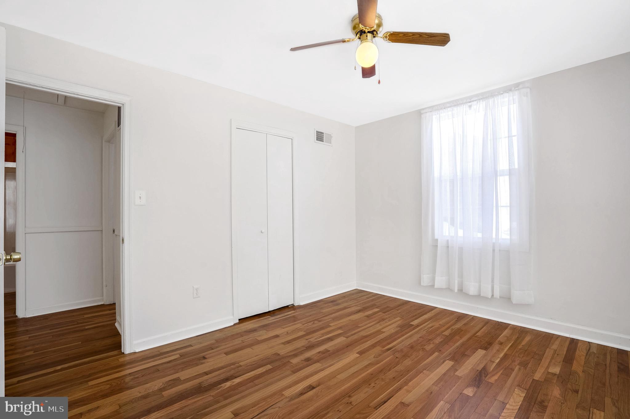 6710 Red Jacket Road Springfield, VA 22152 - Photo 38 of 53 a view of empty room with wooden floor and fan