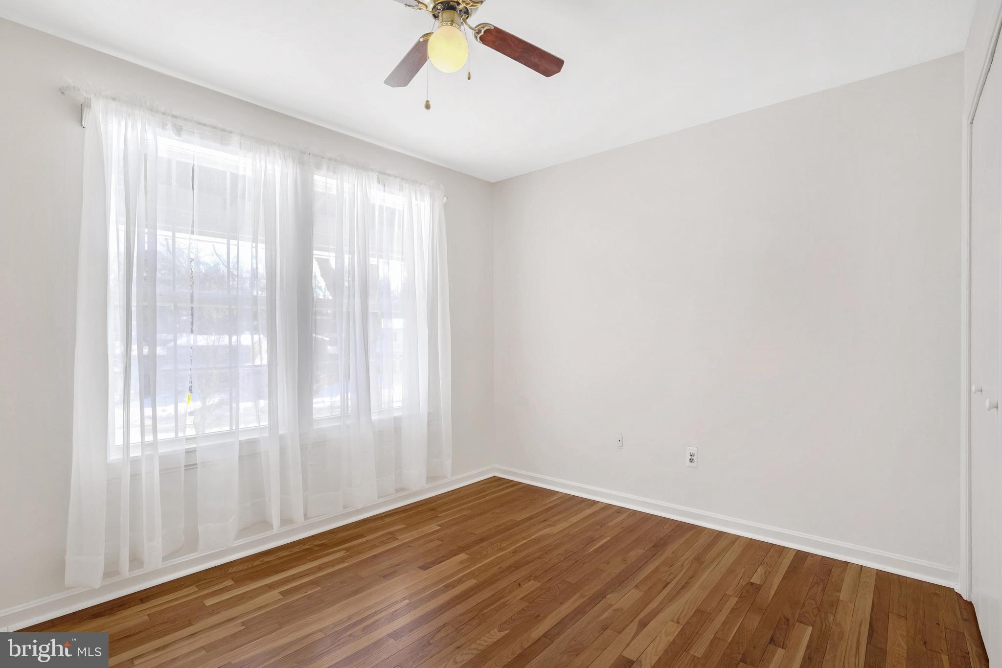 6710 Red Jacket Road Springfield, VA 22152 - Photo 40 of 53 a view of an empty room with wooden floor and a window