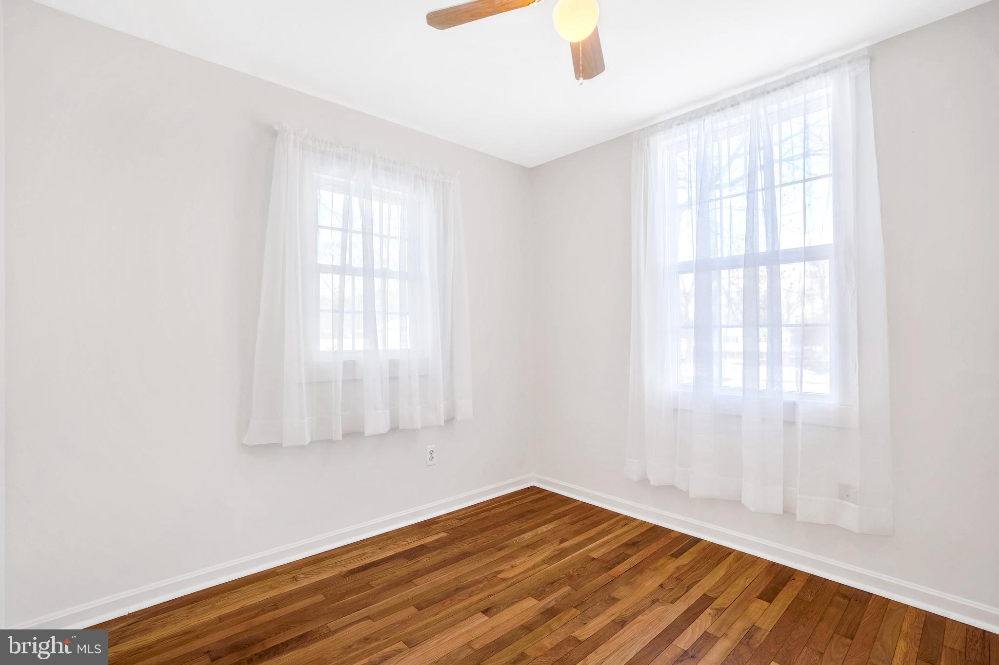 6710 Red Jacket Road Springfield, VA 22152 - Photo 42 of 53 an empty room with wooden floor and windows