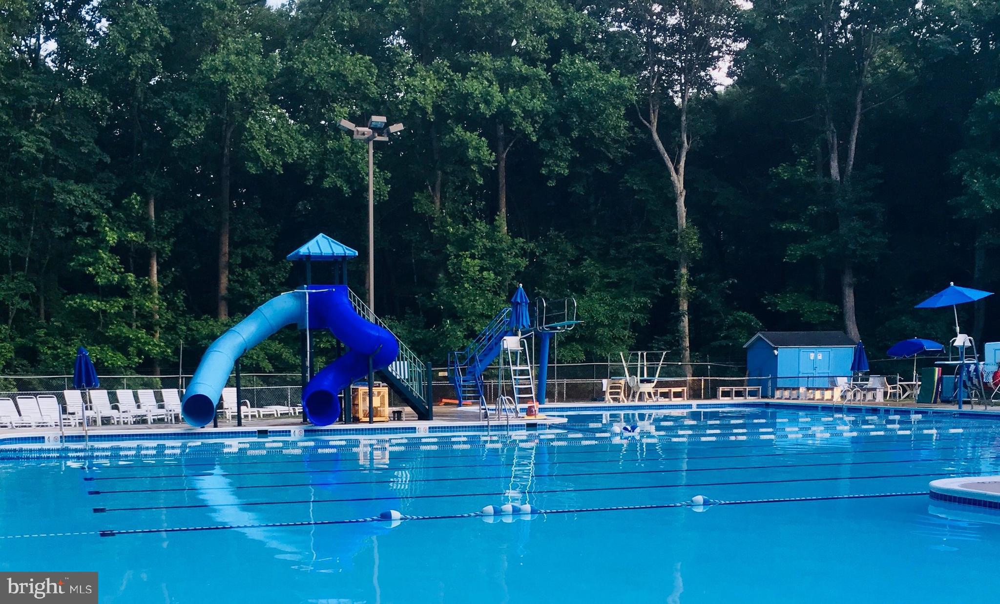6710 Red Jacket Road Springfield, VA 22152 - Photo 51 of 53 a view of swimming pool with table and chairs a fire pit