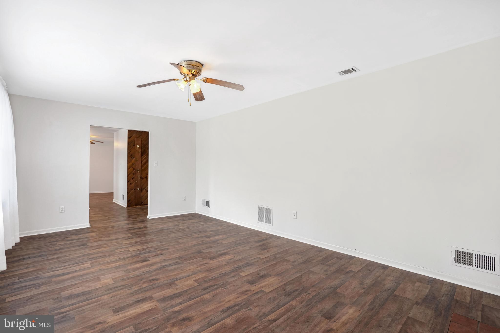 6710 Red Jacket Road Springfield, VA 22152 - Photo 6 of 53 a view of a room with wooden floor and ceiling fan
