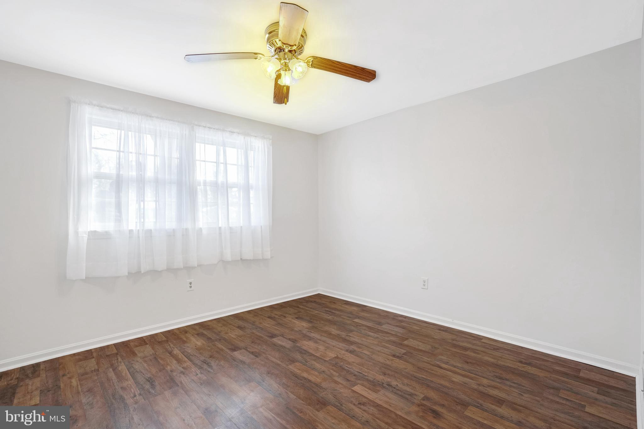 6710 Red Jacket Road Springfield, VA 22152 - Photo 7 of 53 an empty room with wooden floor and windows