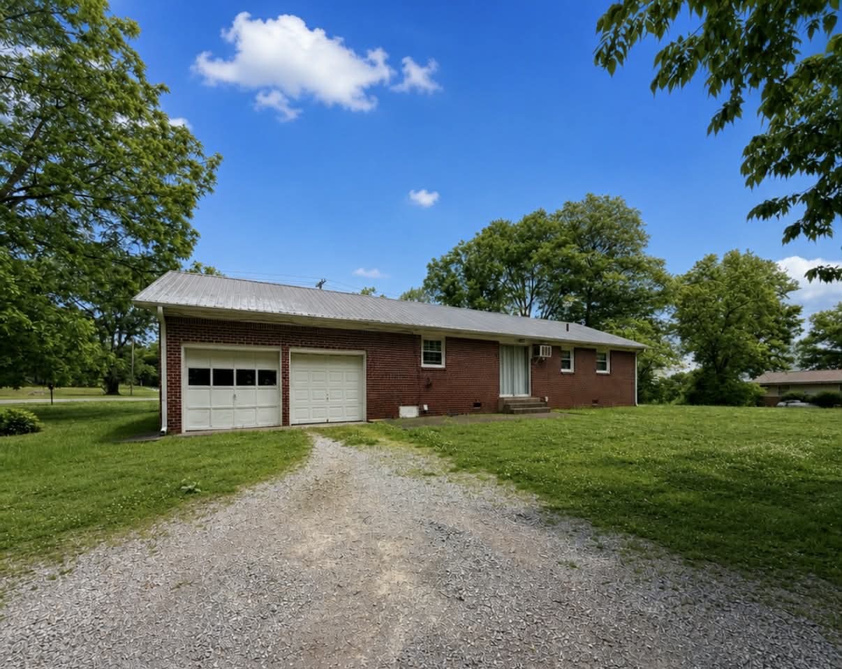 955 Rocky Road Pulaski, TN 38478 - Photo 2 of 10 a front view of a house with yard and tree