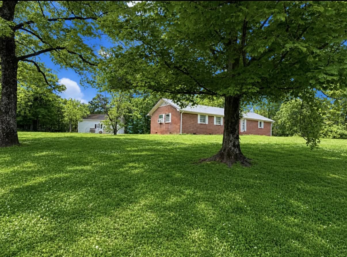 955 Rocky Road Pulaski, TN 38478 - Photo 4 of 10 a house view with a play ground in front of it