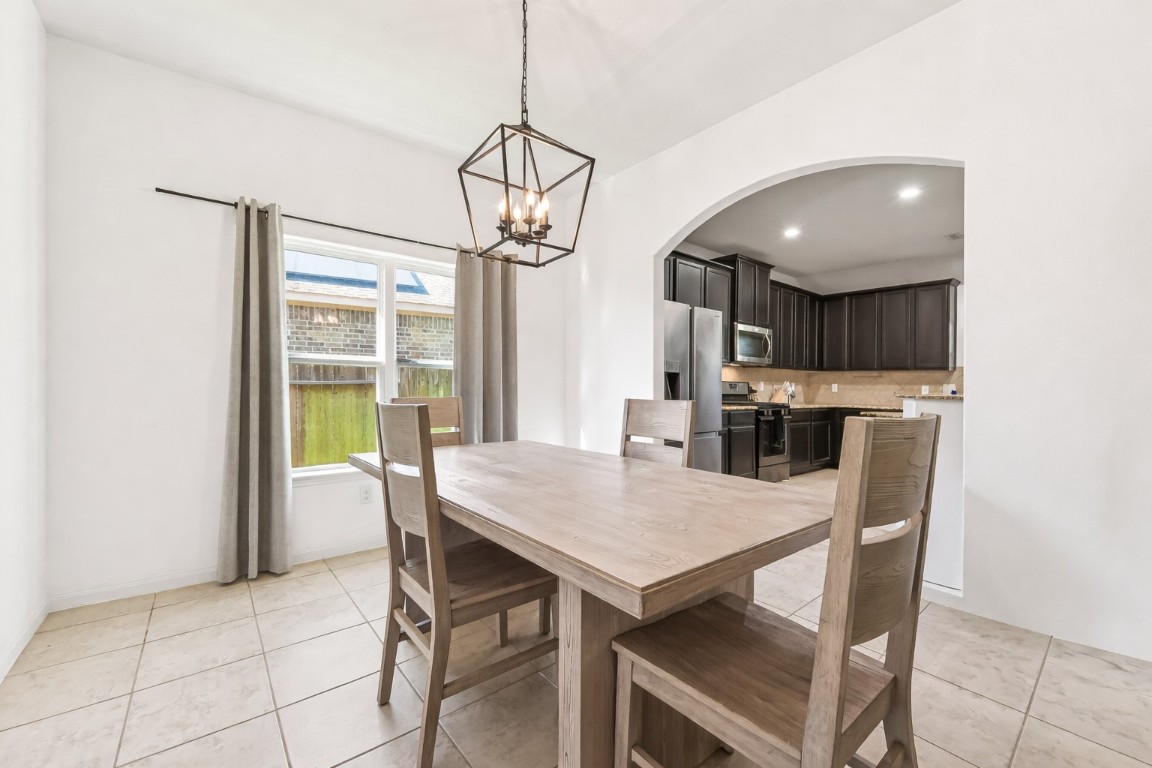 9022 Nina Road Conroe, TX 77304 - Photo 6 of 13 A bright, inviting dining space where morning coffee and evening meals feel equally special.