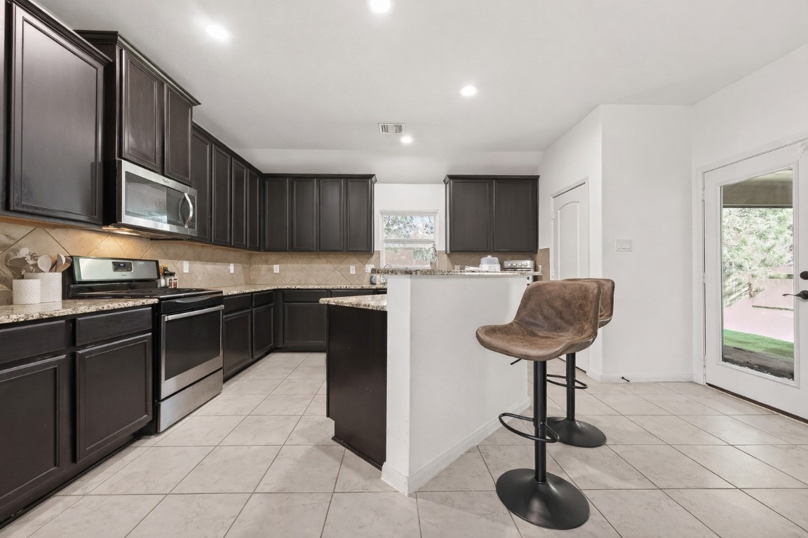 9022 Nina Road Conroe, TX 77304 - Photo 7 of 13 Thoughtfully designed with stylish finishes and ample workspace, ideal for both everyday cooking and entertaining.