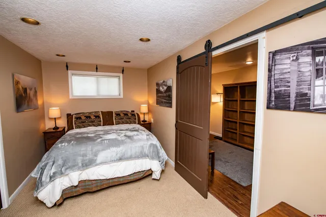a bed sitting in a bedroom next to a window