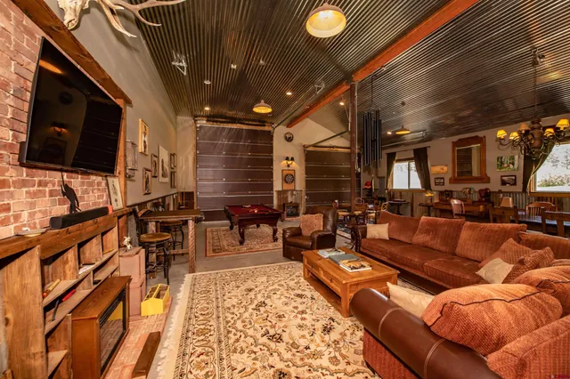 a room with furniture pool table and windows