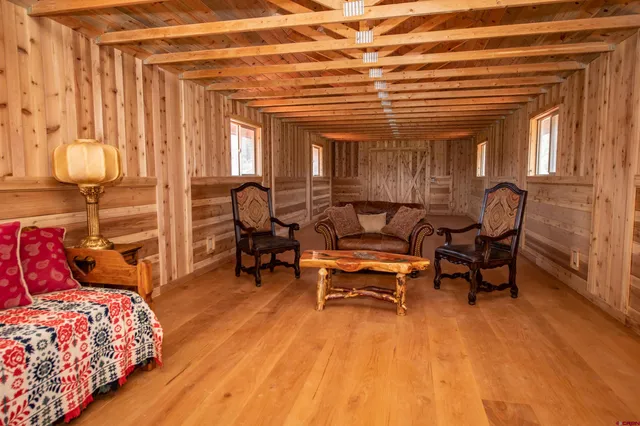 a view of a deck with wooden floor next to a yard