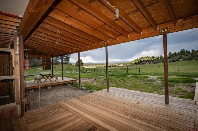 a view of a porch with wooden floor and roof