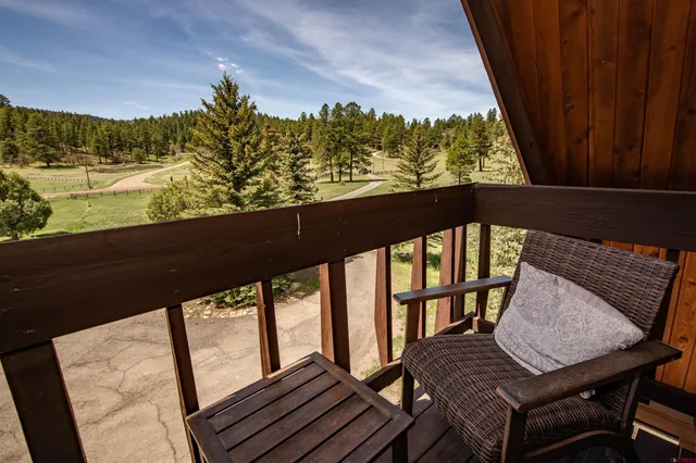 a view of a balcony with wooden floor and outdoor space