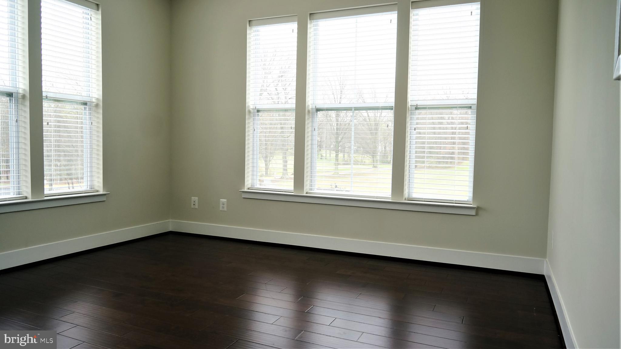 1951 Reston Vly Way, Unit 10 Reston, VA 20191 - Photo 33 of 50 a view of an empty room with wooden floor and a window