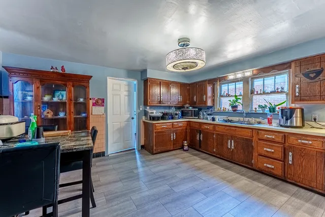 a kitchen with stainless steel appliances granite countertop a stove a sink dishwasher and a refrigerator