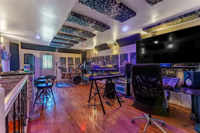 a view of a room with lots of furniture and clutter