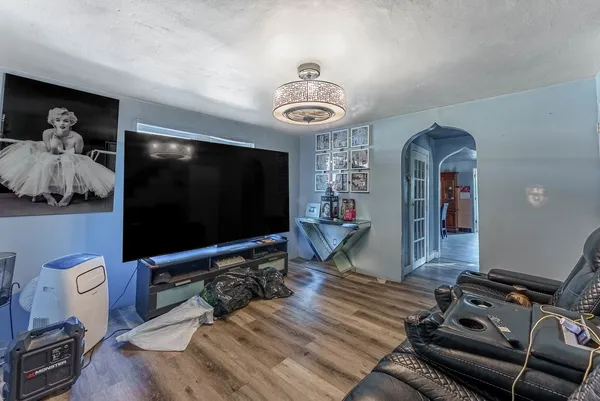 a living room with furniture and a flat screen tv