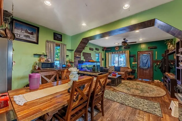 a living room with furniture a flat screen tv and outdoor view