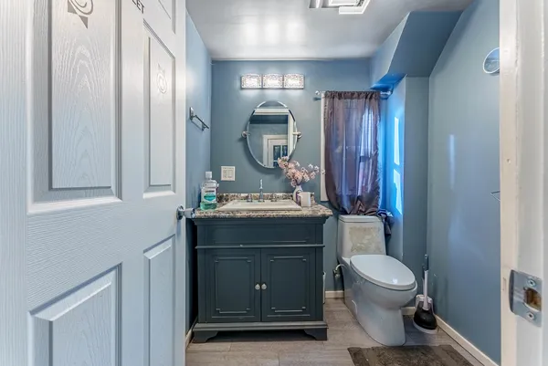 a bathroom with a toilet sink and mirror