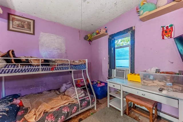 a bedroom with a bed and a dresser