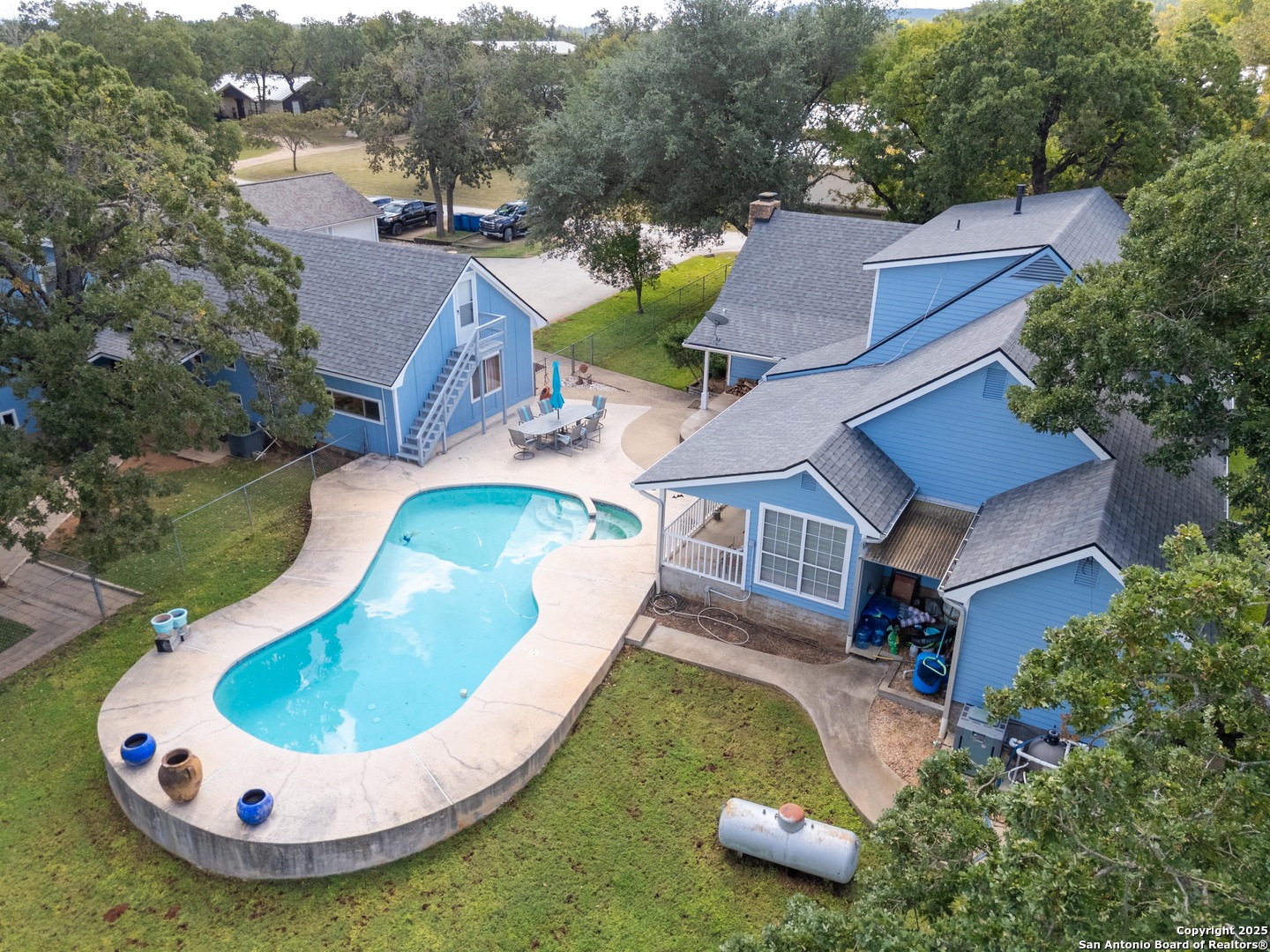 an aerial view of a house with swimming pool and mountain view