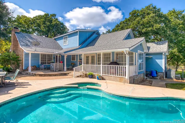 a bathroom with a granite countertop toilet sink and mirror
