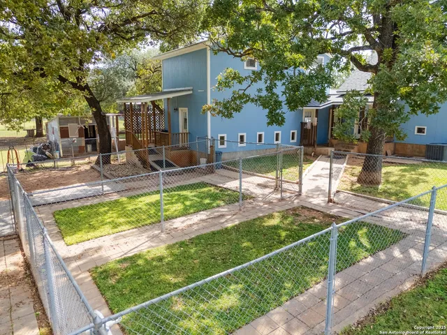 a view of a backyard with plants and patio