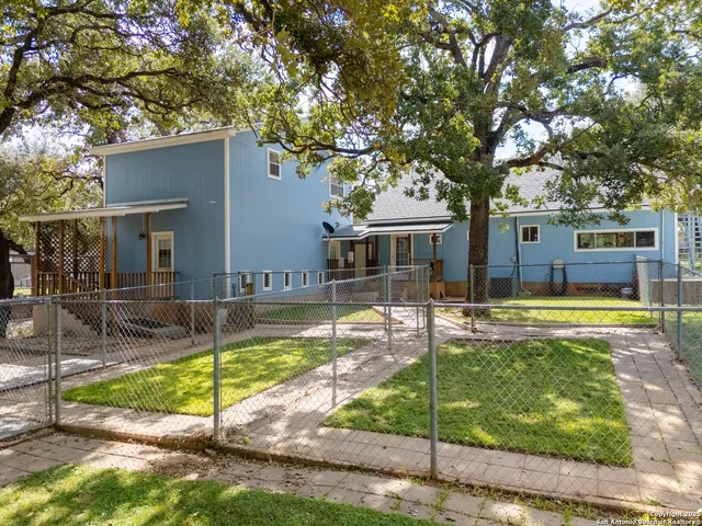 a view of a house with swimming pool and a yard