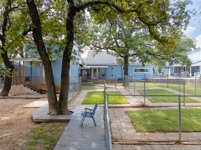 a view of a house with swimming pool and a yard