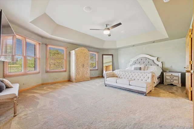 a spacious bedroom with a large bed and a large window