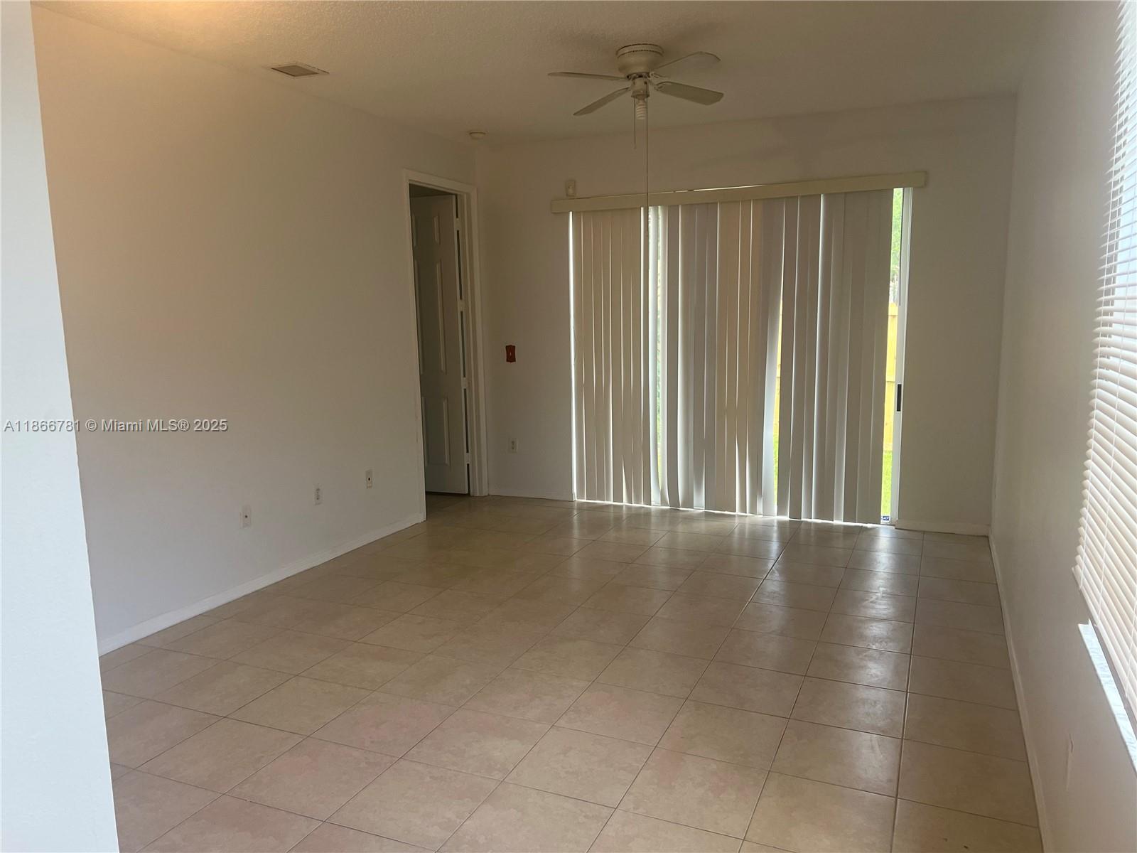 4287 Northeast 9th Street Homestead, FL 33033 - Photo 14 of 25 en empty room with windows and ceiling fan
