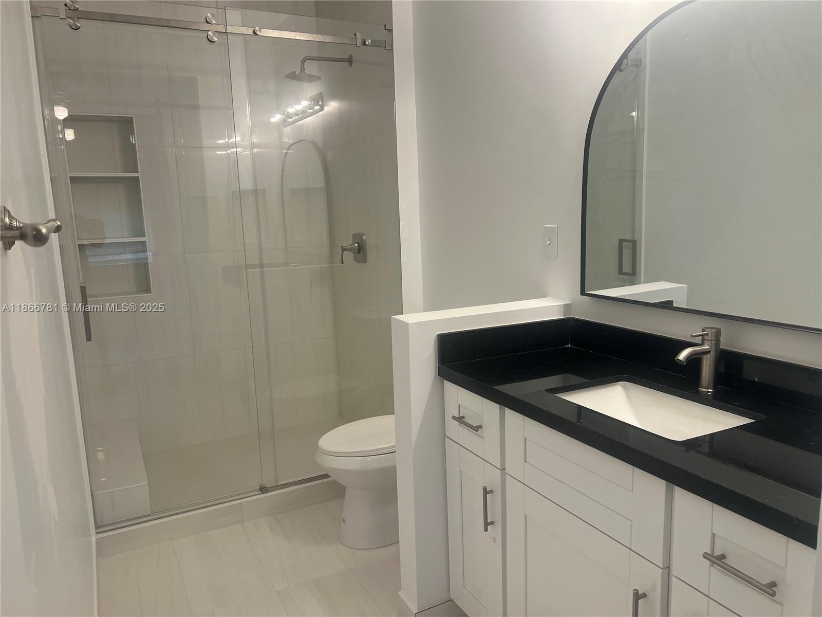 4287 Northeast 9th Street Homestead, FL 33033 - Photo 16 of 25 a bathroom with a granite countertop sink a toilet and a mirror