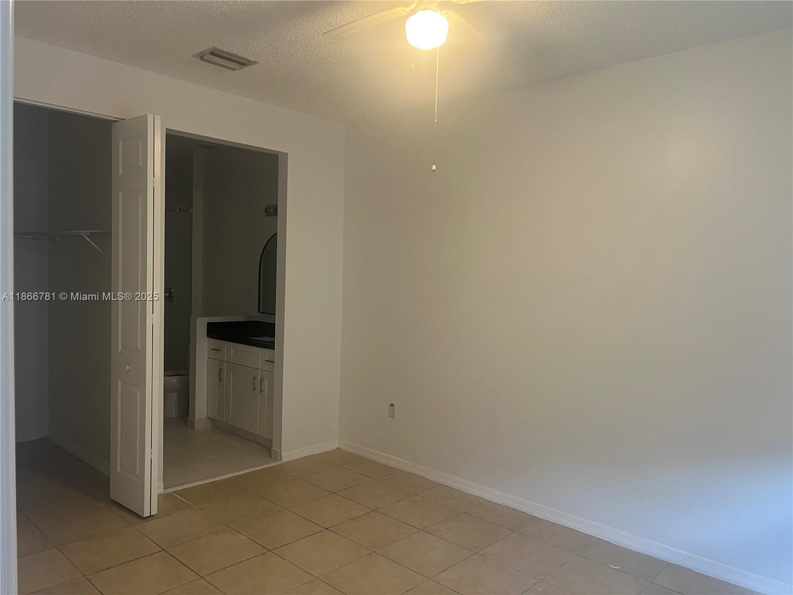 4287 Northeast 9th Street Homestead, FL 33033 - Photo 17 of 25 an empty room with an entrance to other room