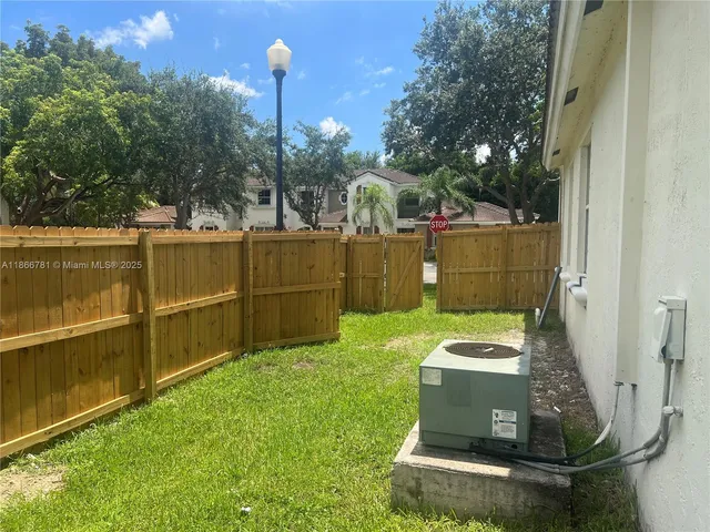 a view of a backyard with large trees
