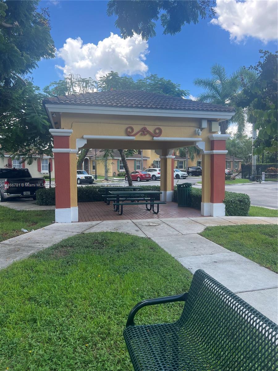 4287 Northeast 9th Street Homestead, FL 33033 - Photo 22 of 25 a living room with patio furniture and a garden
