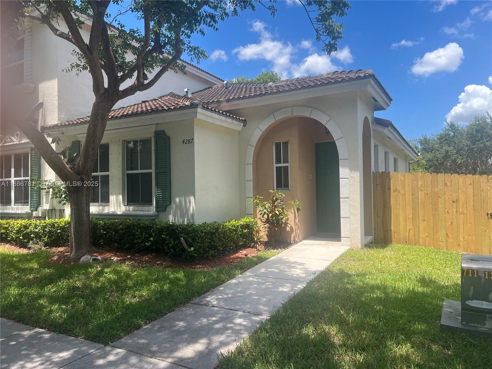 4287 Northeast 9th Street Homestead, FL 33033 - Photo 4 of 25 a front view of a house with garden