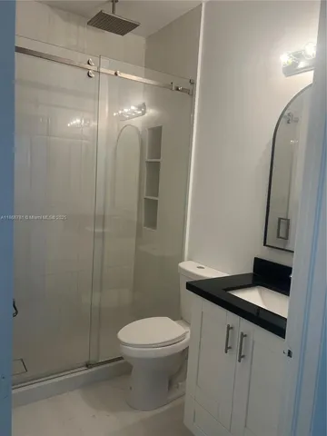 a bathroom with a toilet a sink and shower