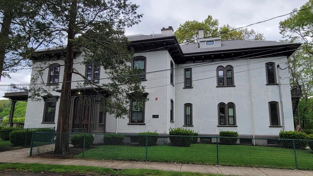 73 Elm Road, Unit 8 Newton, MA 02460 - Photo 1 of 12 a front view of a house with a garden