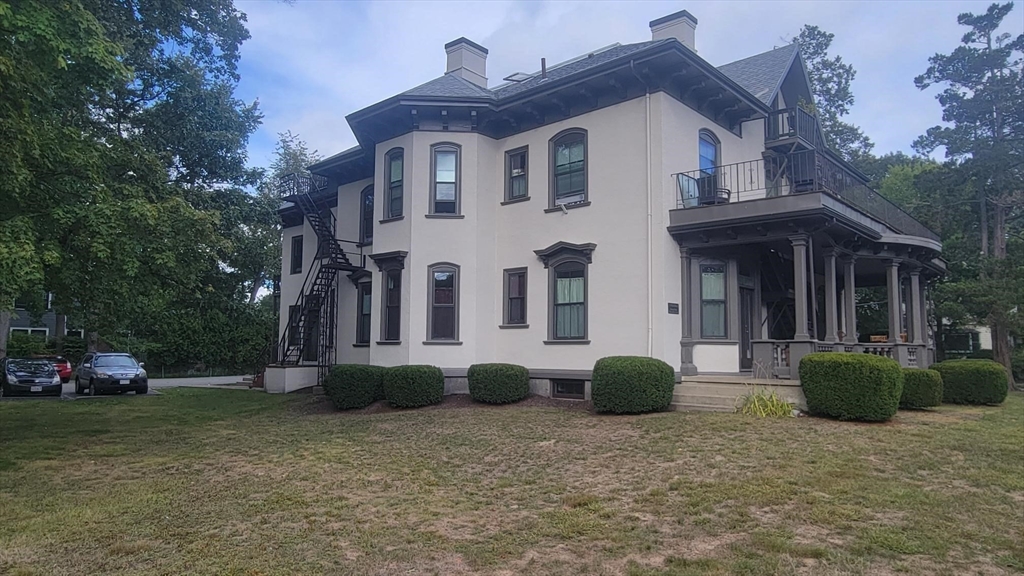 73 Elm Road, Unit 8 Newton, MA 02460 - Photo 11 of 12 a view of a house with a backyard