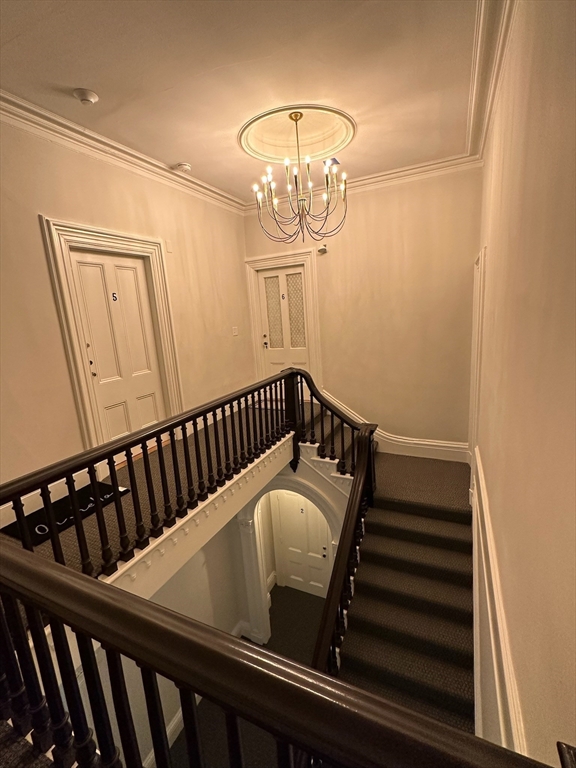 73 Elm Road, Unit 8 Newton, MA 02460 - Photo 4 of 12 a view of staircase with railing and a chandelier