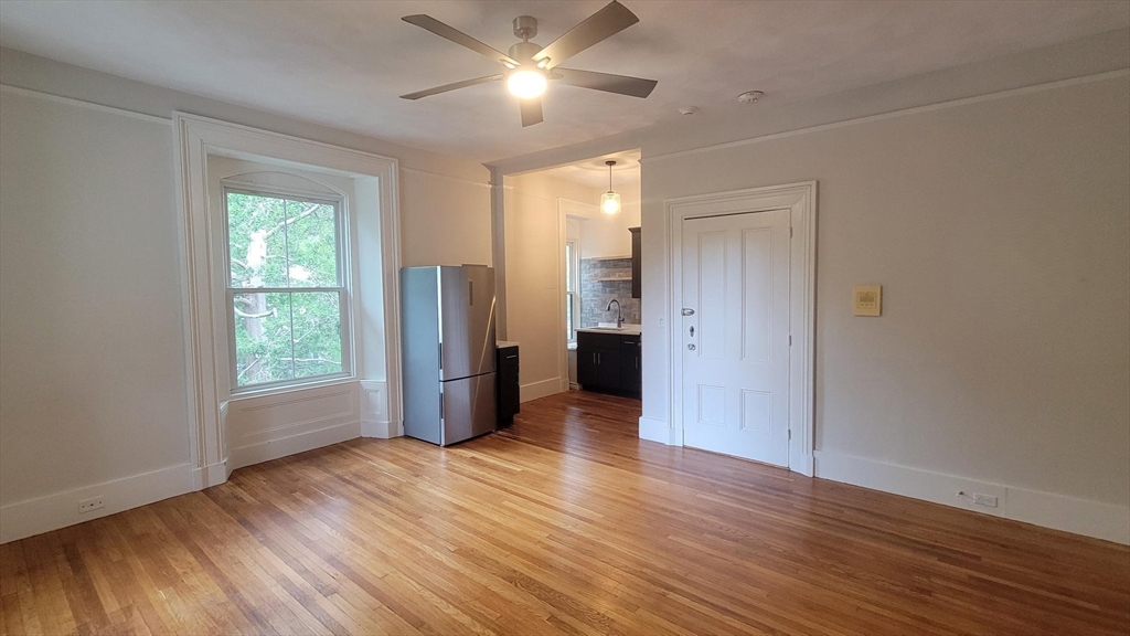 73 Elm Road, Unit 8 Newton, MA 02460 - Photo 6 of 12 a view of an empty room with wooden floor and a window