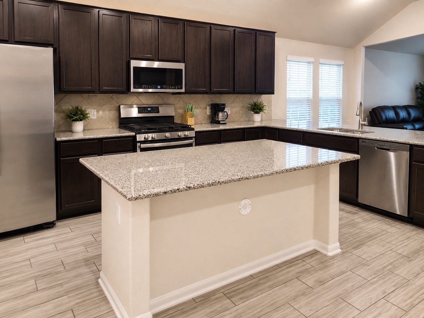 1058 Ranch Oak Drive Houston, TX 77073 - Photo 8 of 27 Spacious island kitchen with granite countertops, 42-inch cabinetry, and gas cooking.