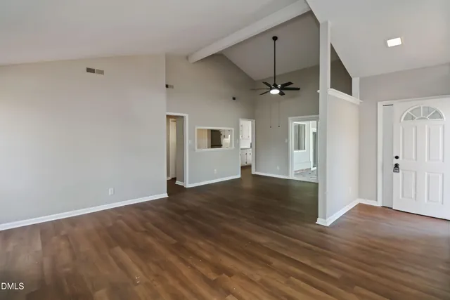 wooden floor in an empty room with a window