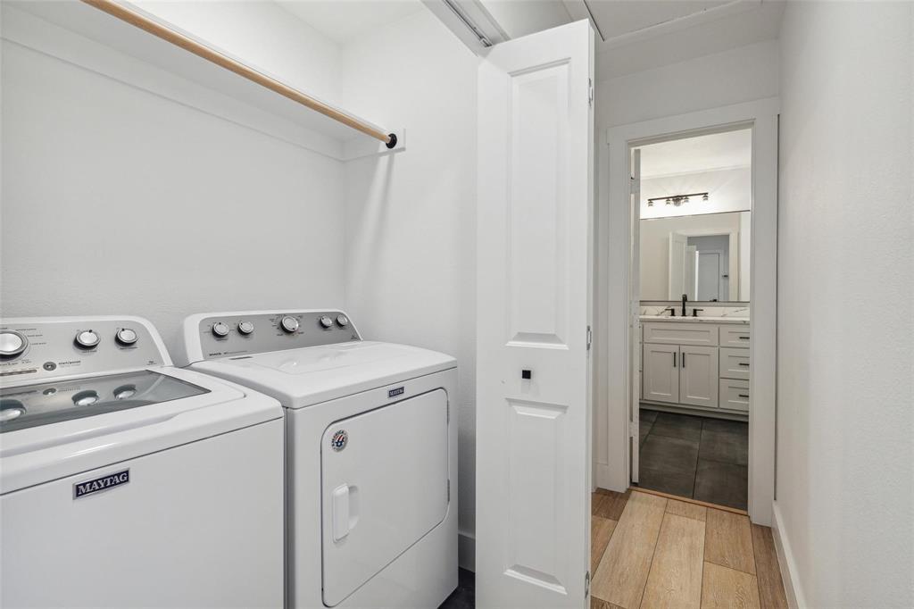 7274 Pecan Street Frisco, TX 75034 - Photo 11 of 13 a view of washer and dryer with bathroom in the background