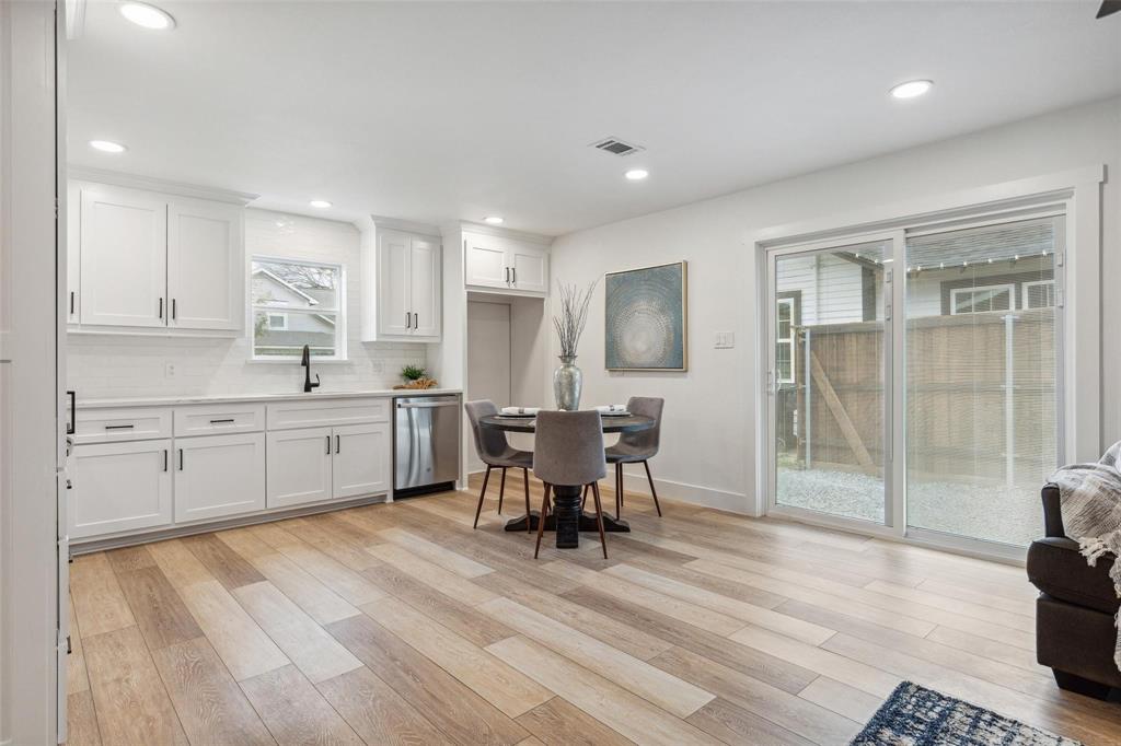 7274 Pecan Street Frisco, TX 75034 - Photo 4 of 13 a kitchen with a table chairs refrigerator and cabinets