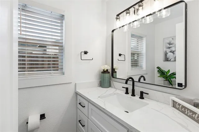 a bathroom with a sink and a large mirror