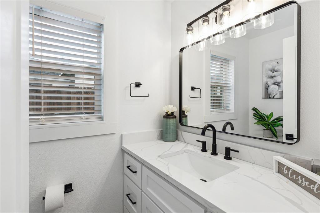 7274 Pecan Street Frisco, TX 75034 - Photo 8 of 13 a bathroom with a sink and a large mirror