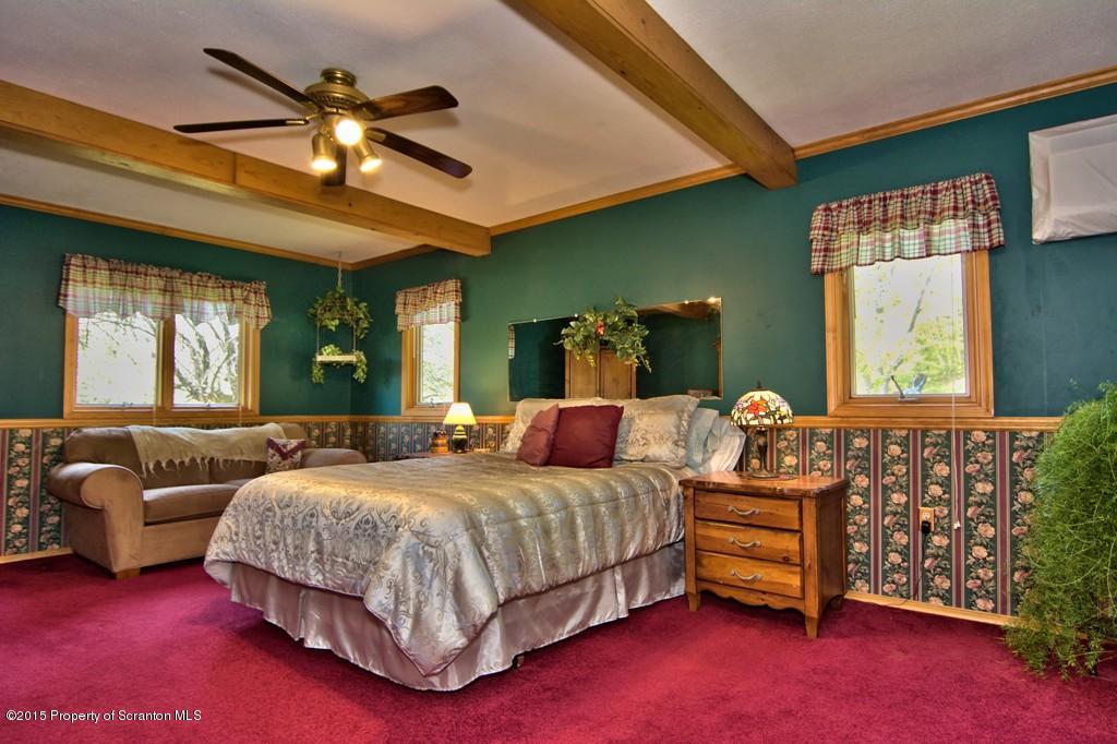 2335 Hamlin Road Moscow, PA 18444 - Photo 21 of 34 a bedroom with a bed and a couch