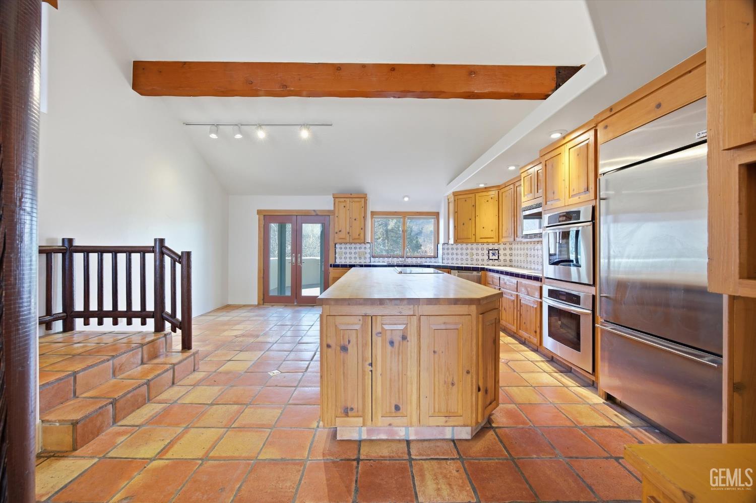 Undisclosed Address Tehachapi, CA 93561 - Photo 18 of 70 a kitchen with stainless steel appliances granite countertop a sink and cabinets