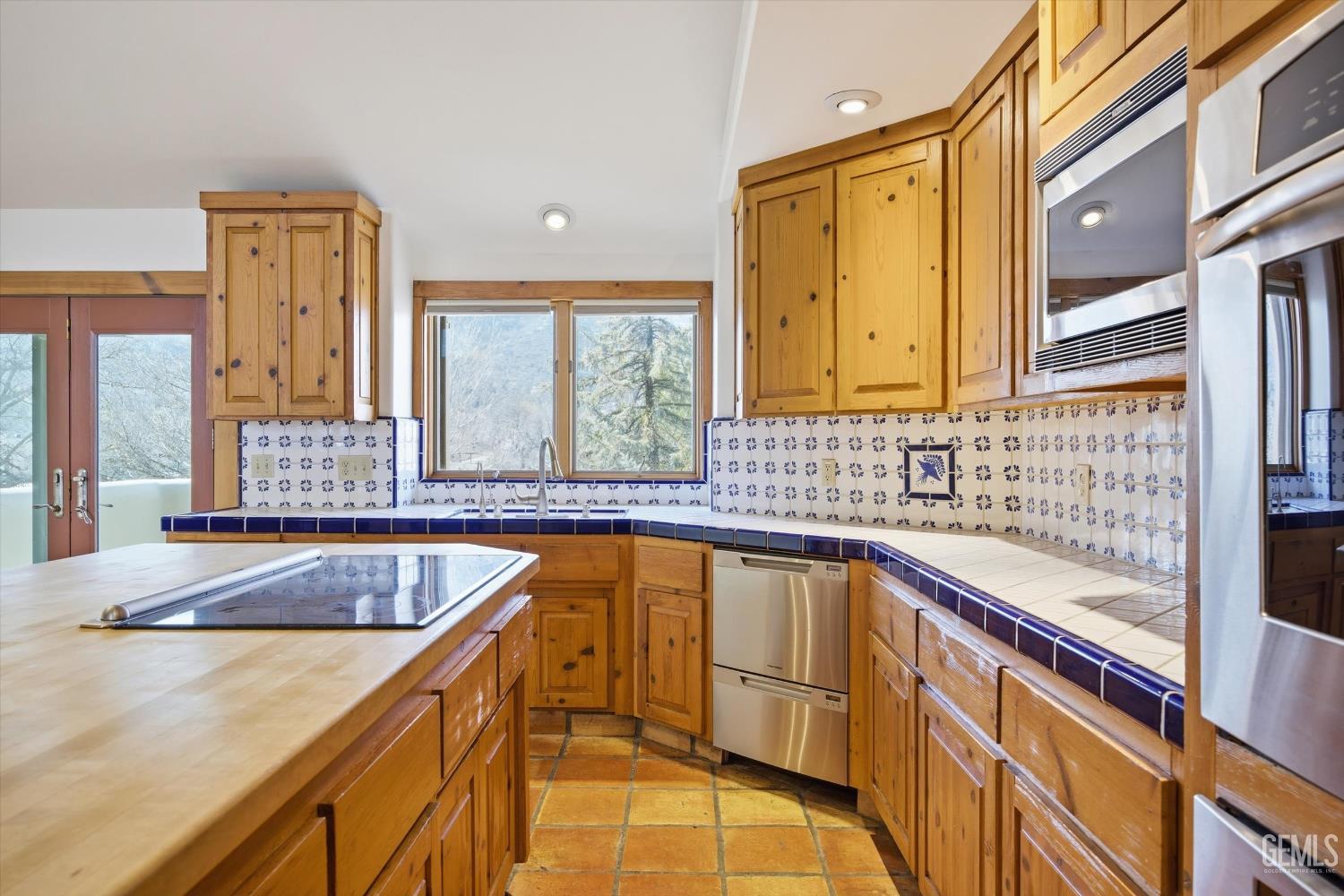 Undisclosed Address Tehachapi, CA 93561 - Photo 25 of 70 a view of a kitchen with granite countertop a sink and a large window